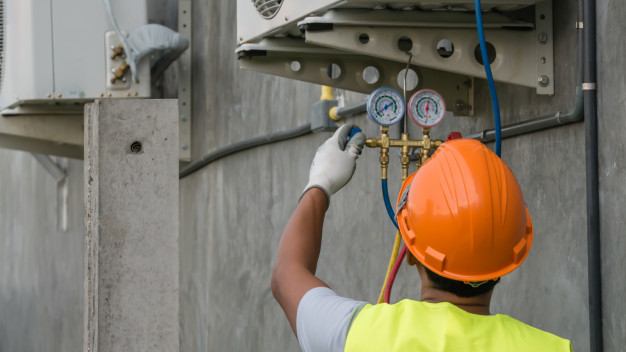 Technician checking A/C unit